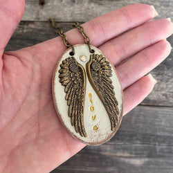 Unique, one of a kind leather pendant necklace with wing design